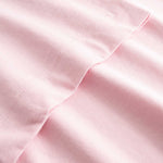 Closeup view of arm stitchings on light pink T-shirt