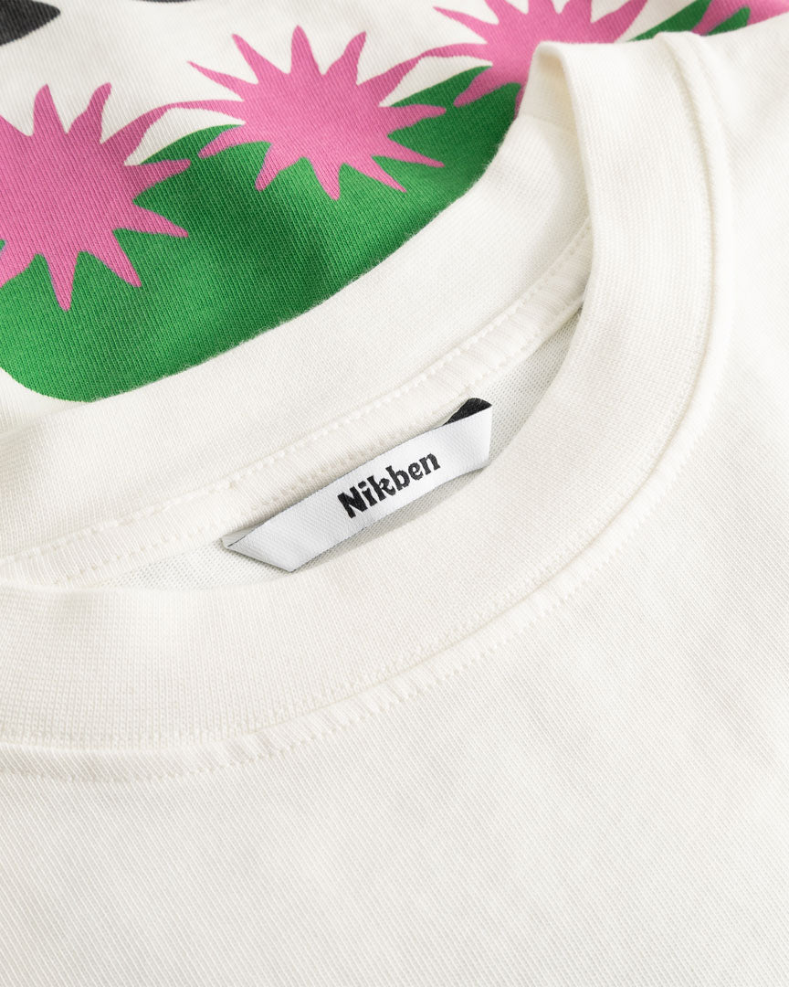 Closeup view of Nikben necklabel on white T-shirt
