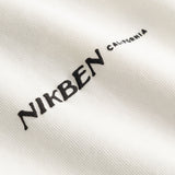 Closeup view of black "Nikben California" logo on white T-shirt