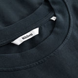 Closeup view of Nikben necklabel on black T-shirt