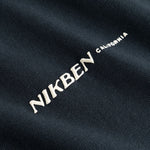 Closeup view of white "Nikben California" logo on black T-shirt