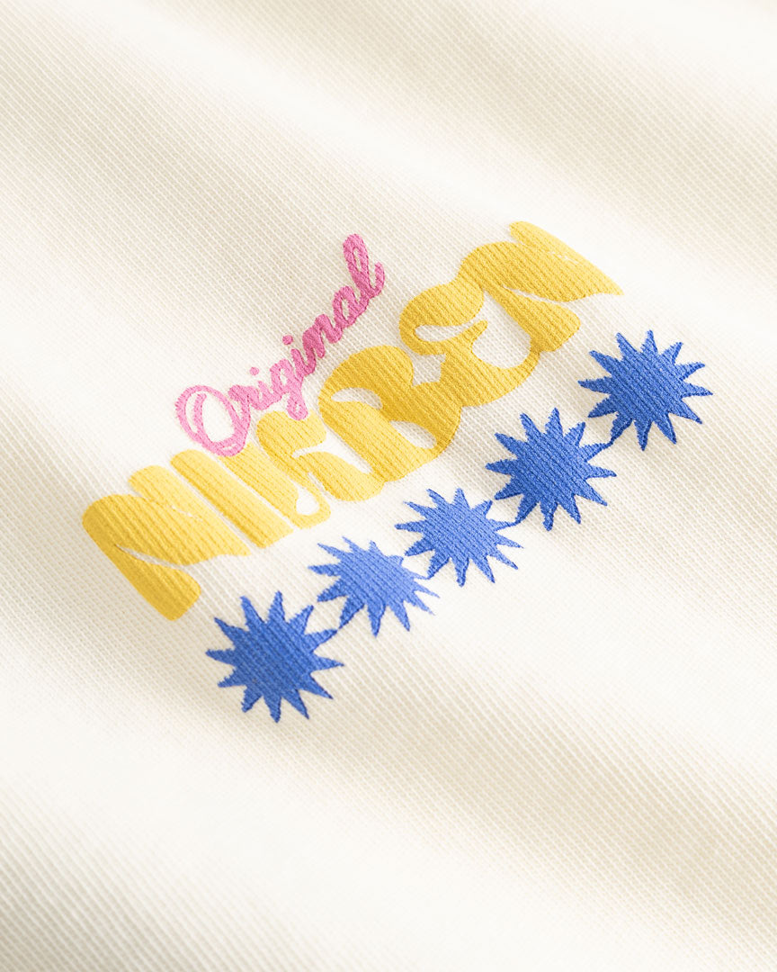 Closeup view of yellow, blue and pink Nikben logo on cream colored T-shirt
