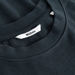 Closeup view of Nikben necklabel on black T-shirt