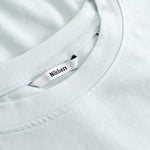 Closeup view of Nikben necklabel on pale blue T-shirt