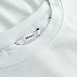 Closeup view of Nikben necklabel on pale blue T-shirt