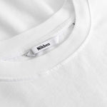 Closeup view of Nikben necklabel on white T-shirt