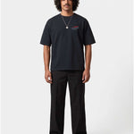 Male model wearing black T-shirt with blue Nikben Airlines logo and red airplane print on the chest