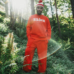 model wearing orange sweatshirt and pants