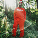 model wearing orange sweatshirt and pants