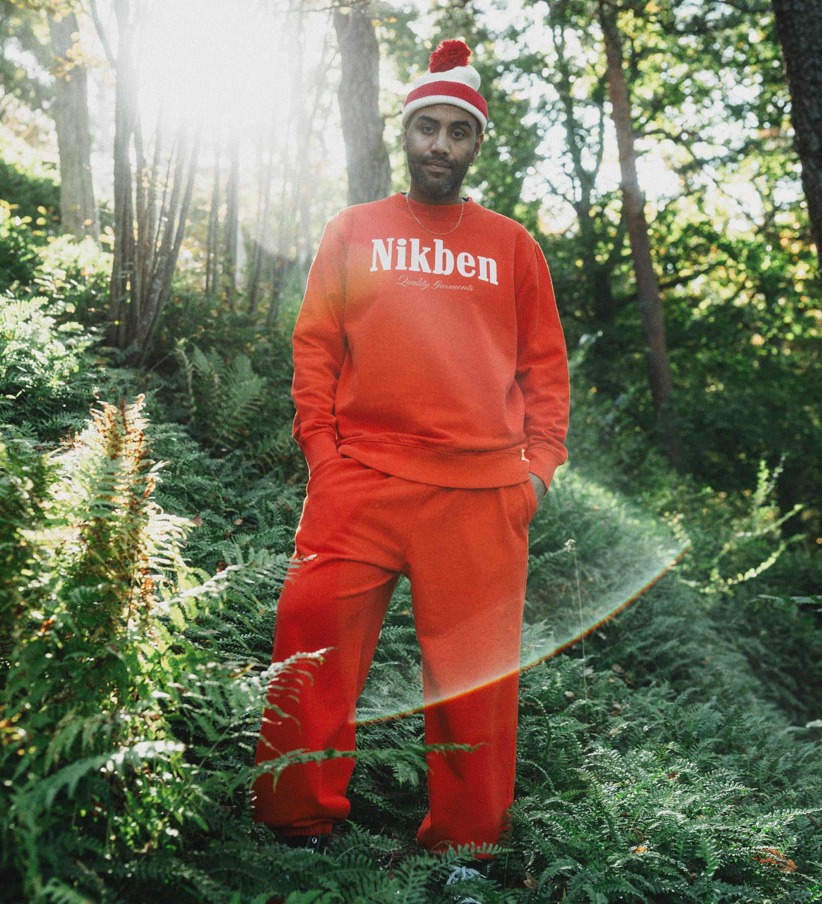 model wearing orange sweatshirt and pants