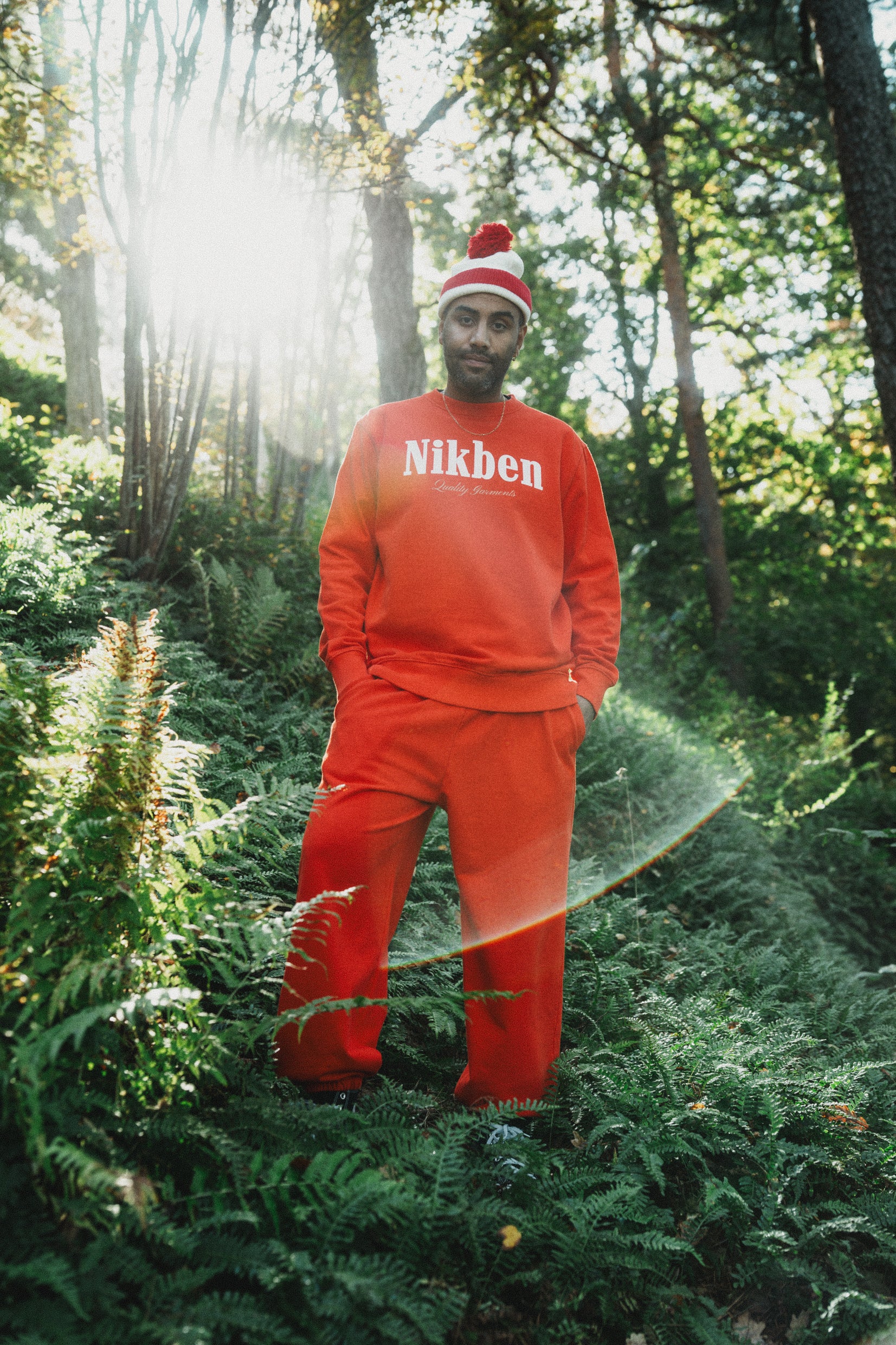 model wearing orange sweatshirt and pants