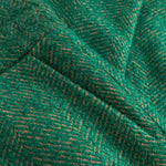 Close-up of green fabric with a herringbone pattern