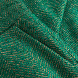 Close-up of green fabric with a herringbone pattern