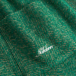 Close-up of green fabric with a subtle pattern and 'Nikben' brand logo.