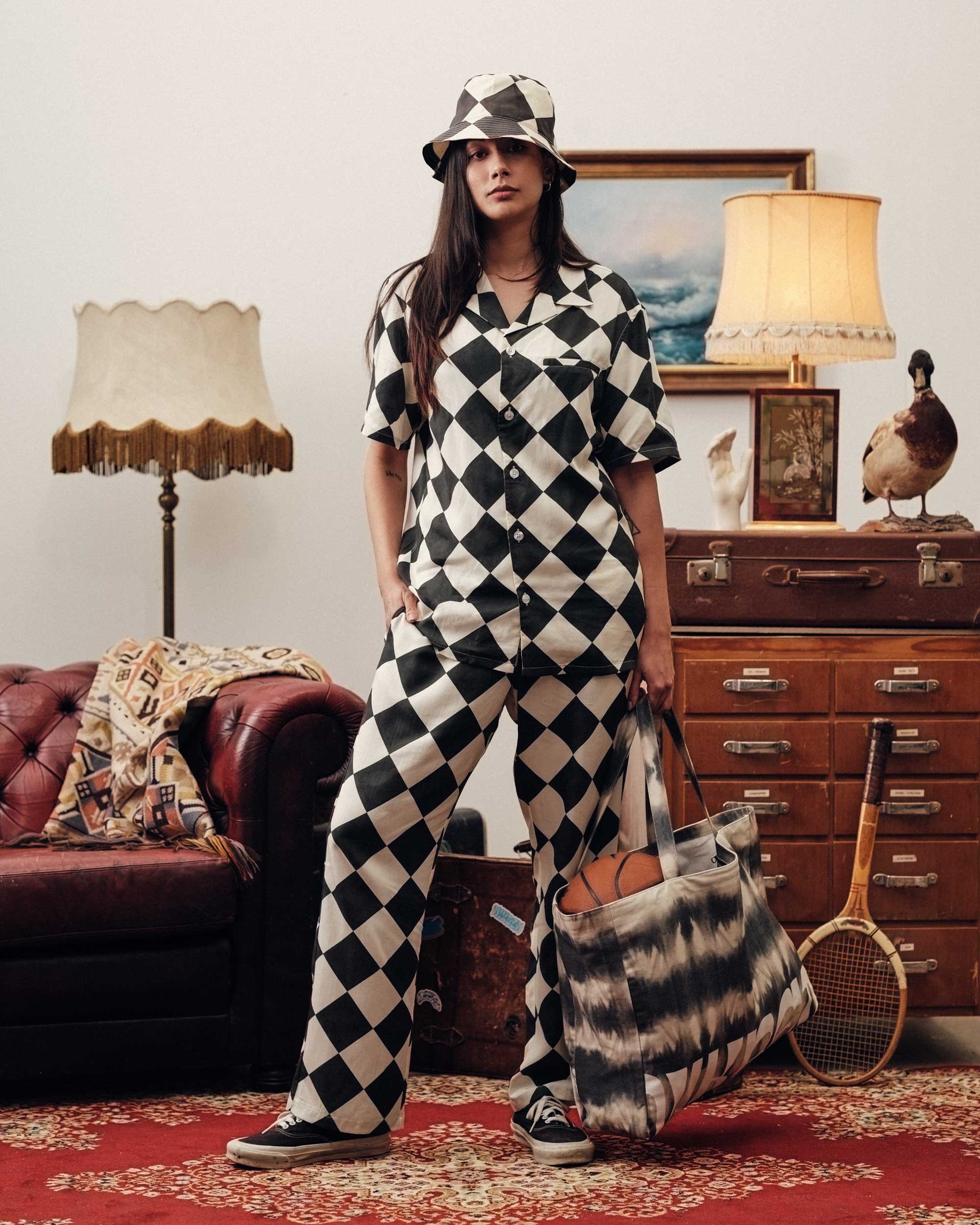 Female model wearing vacation pants with black and white checkered pattern.