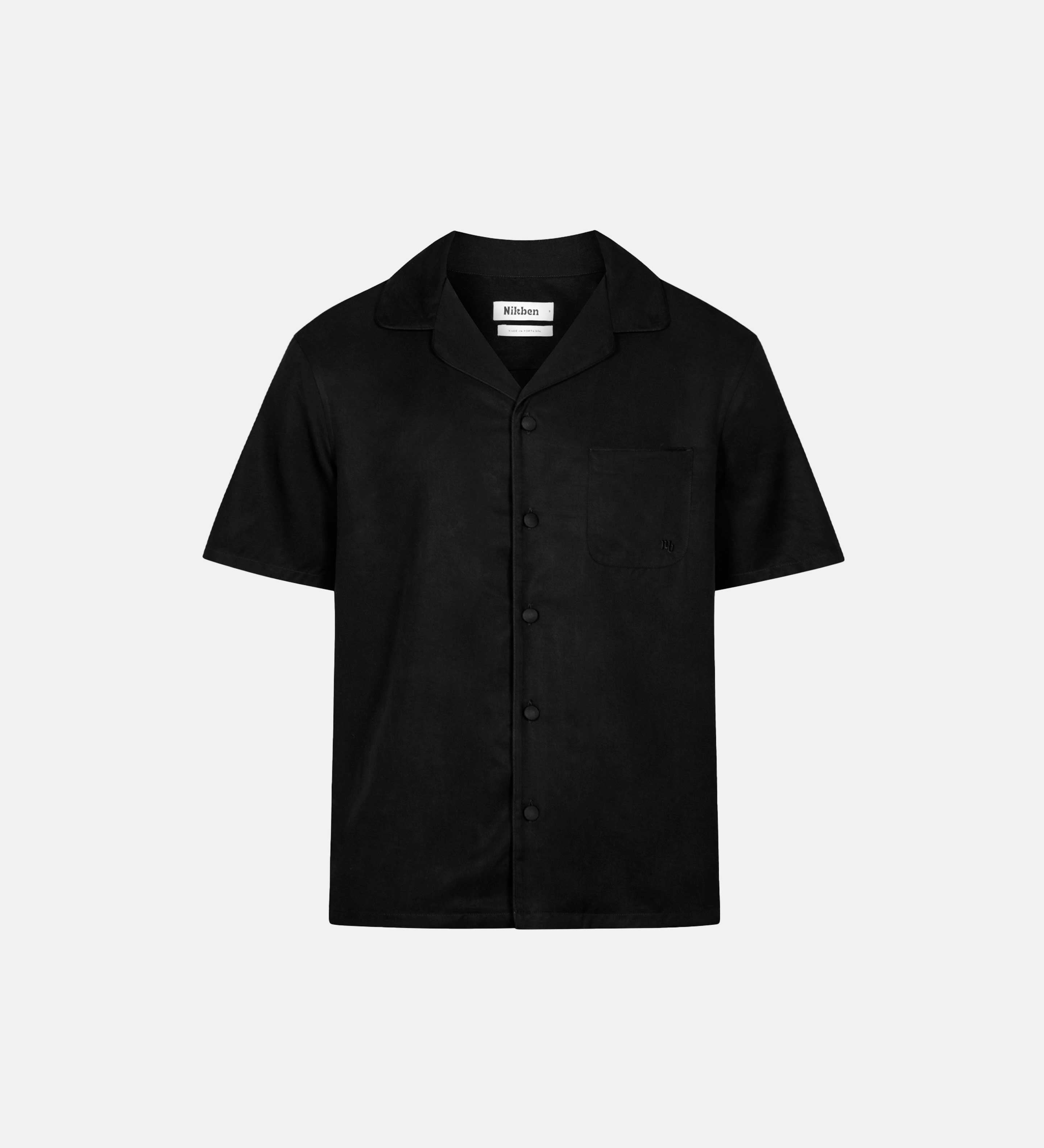 Black short-sleeved vacation shirt with an open collar, one breast pocket, and button closure.