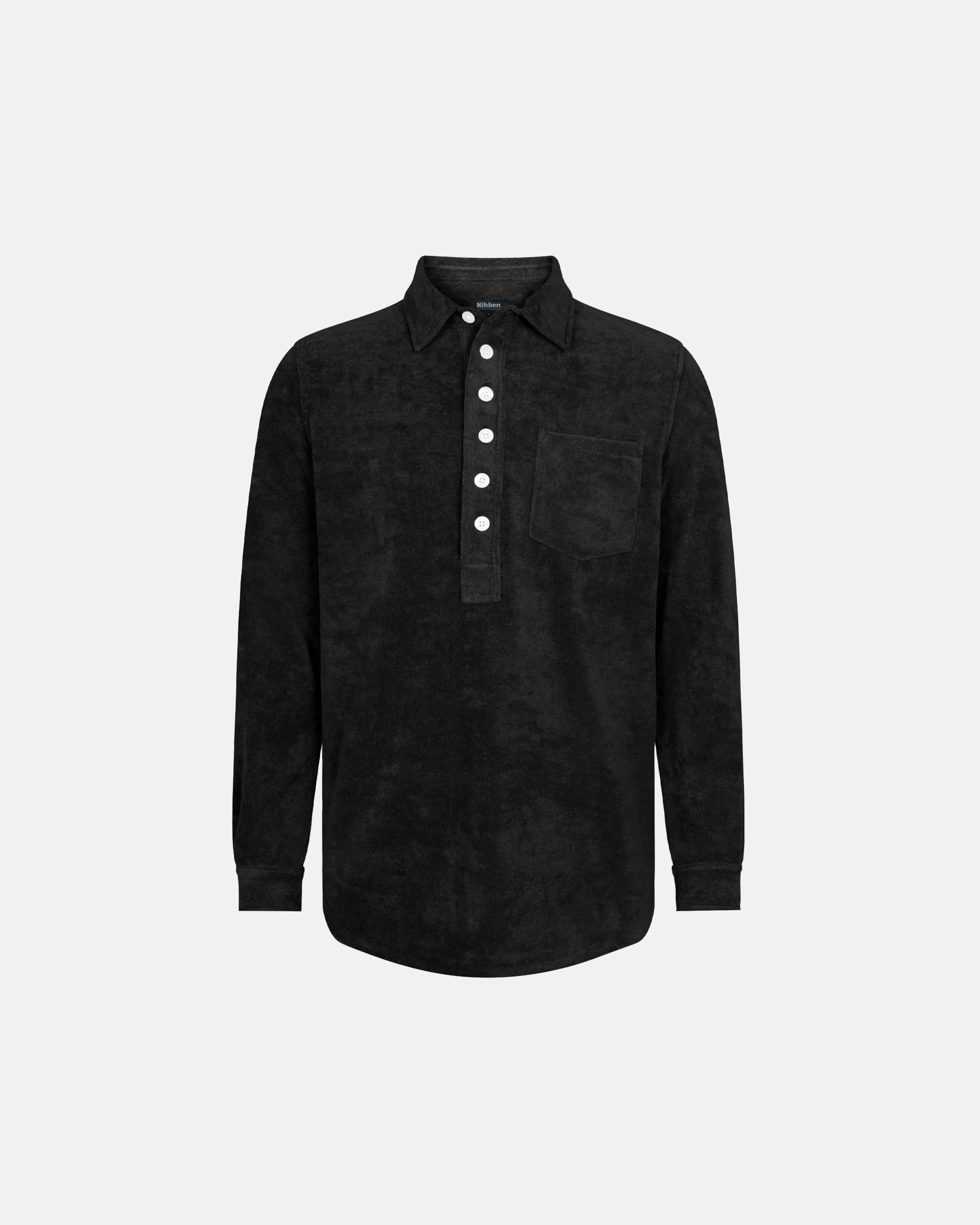 Black long sleeve shirt in terry toweling fabric with half button closure and one chest pocket