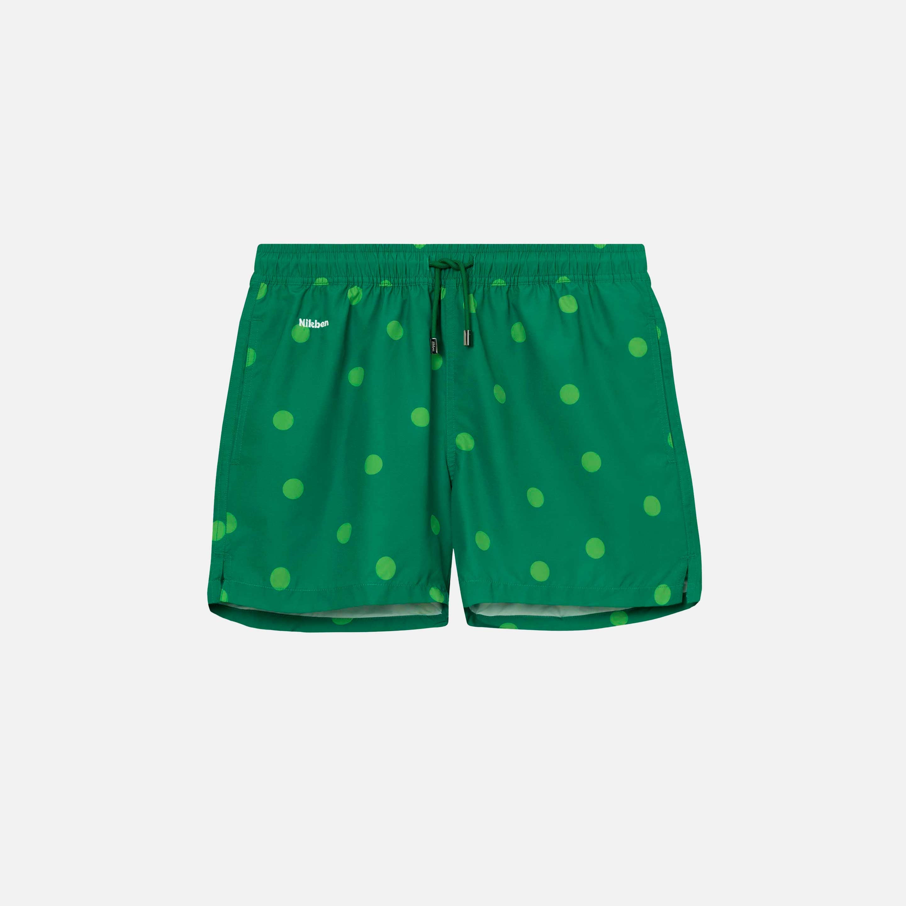 Green swim trunks with light green dots print. Mid length shorts with drawstring waistband and two side pockets.
