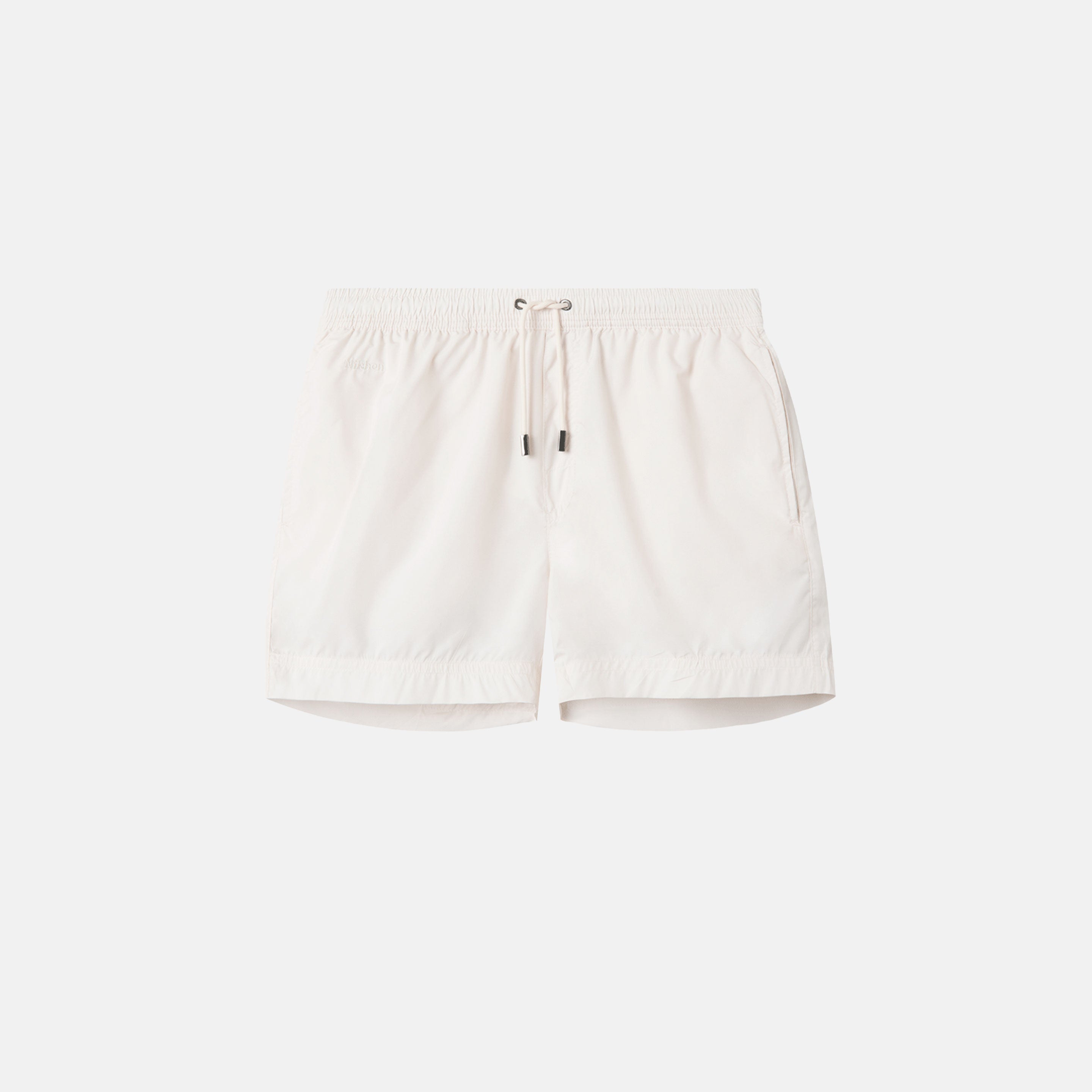 Cream white swim trunks. Mid length with drawstring and two side pockets.