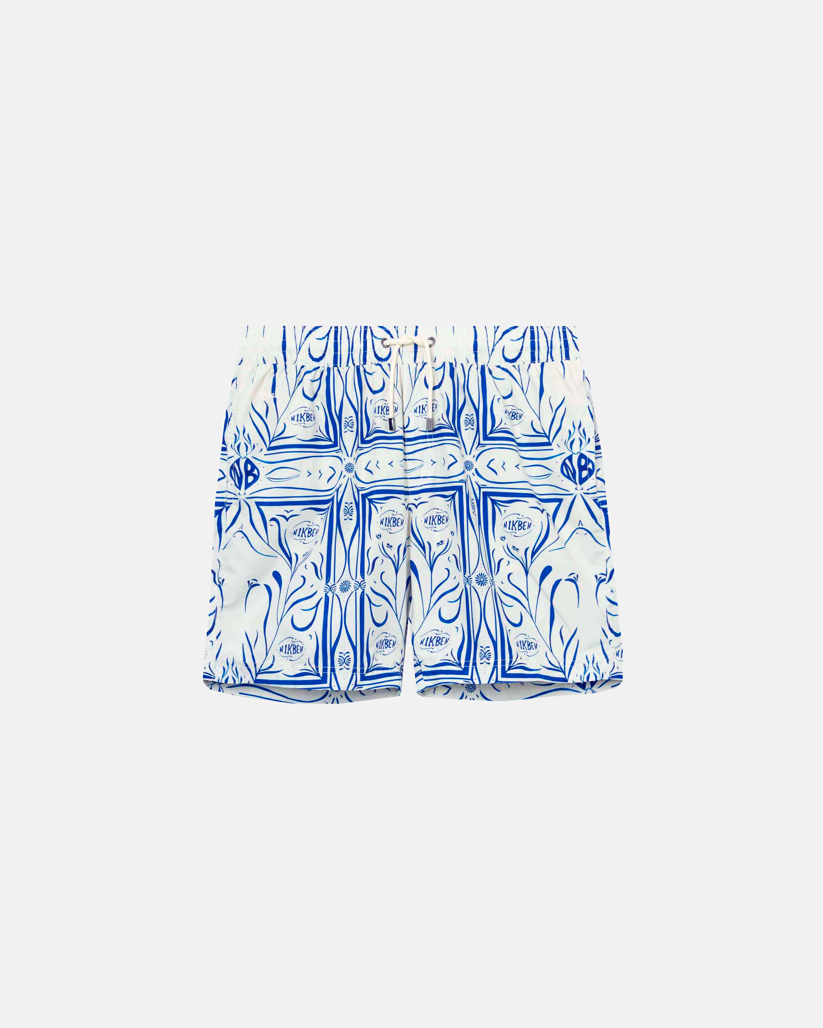 White swim trunks with blue pattern print. Mid length with drawstring and two side pockets.