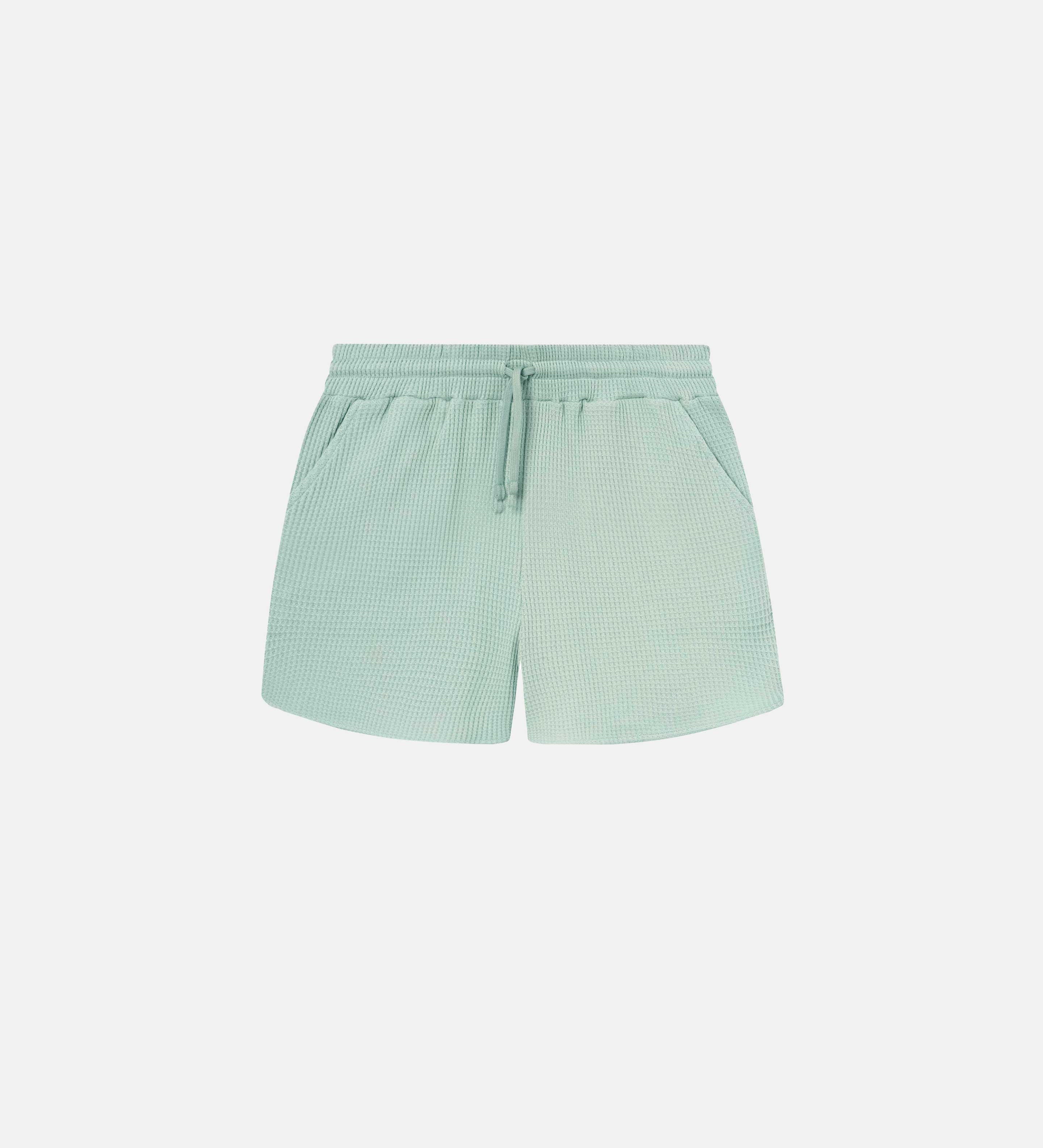 Mint green waffle-patterned short-length shorts with two front pockets and a drawstring.