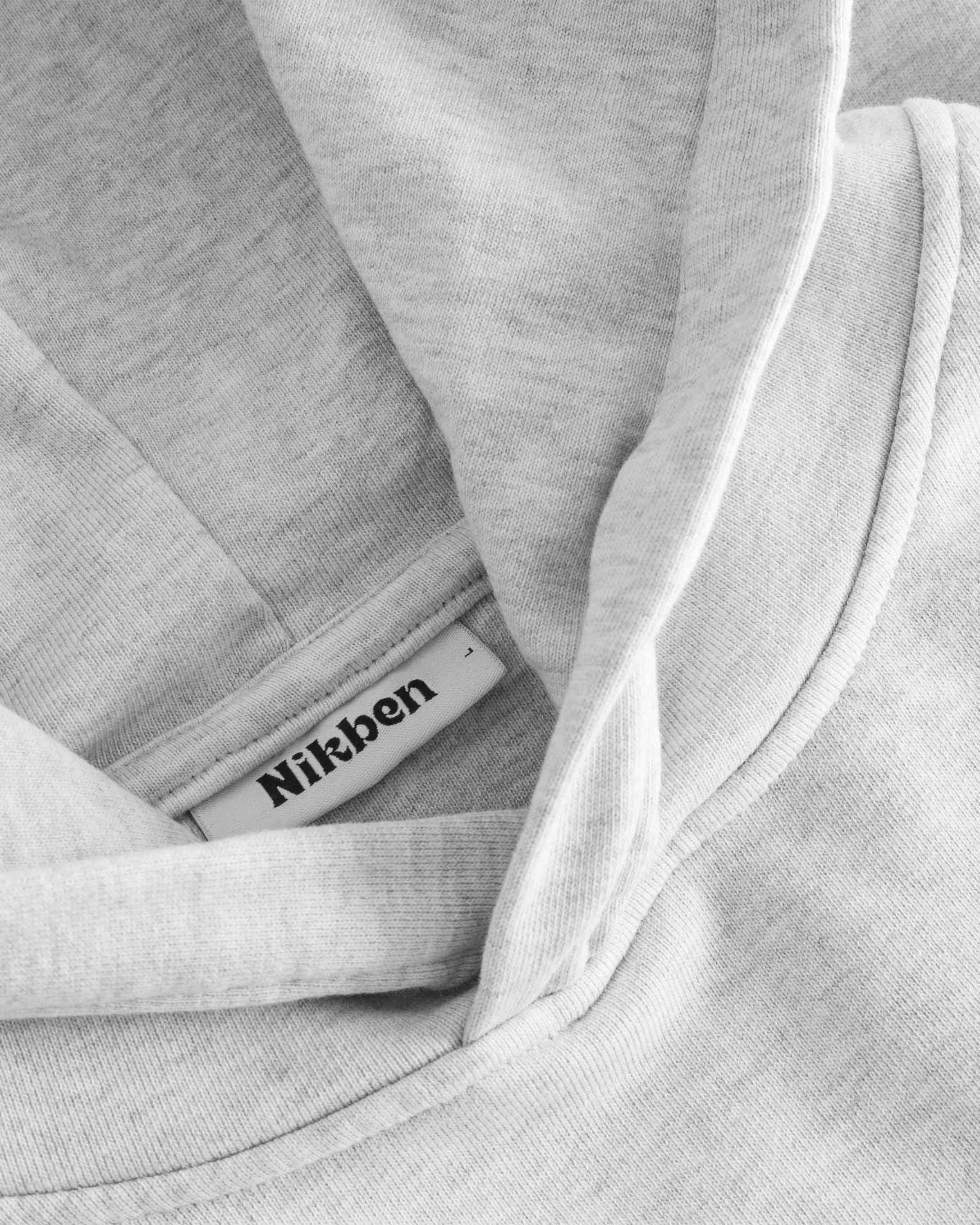 Close-up of stitchings on a grey hoodie.