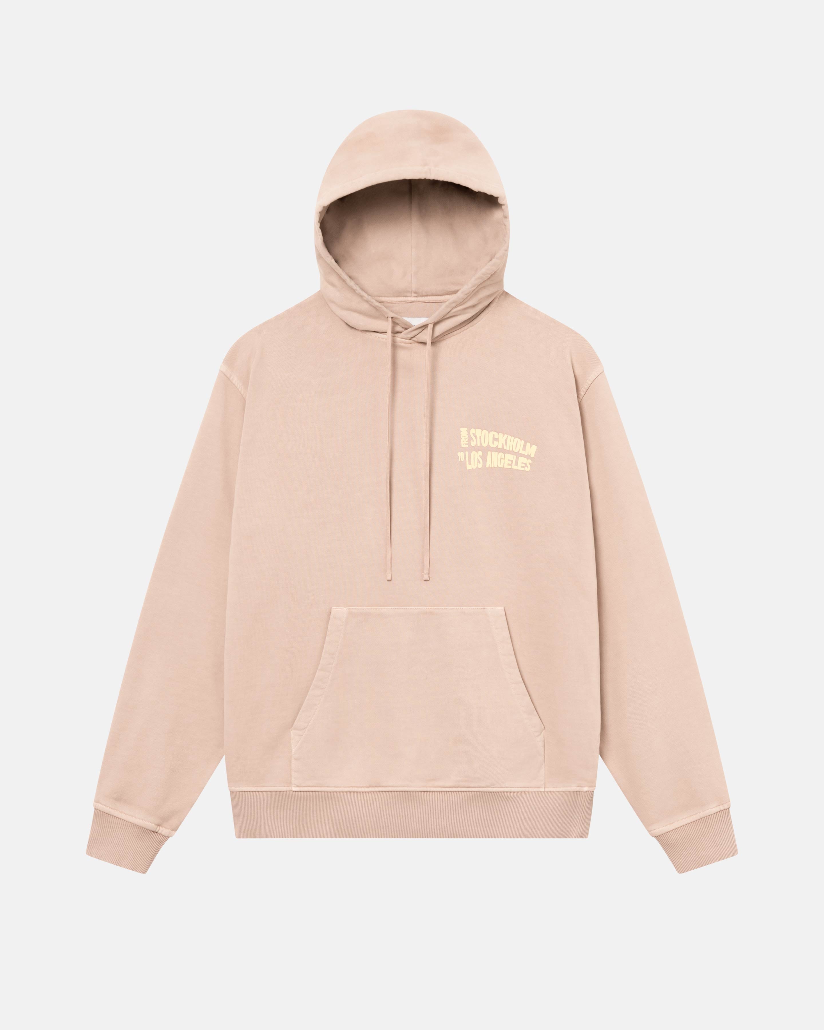 Close up of a brown hoodie with a yellow text print on its chest