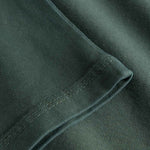 Close-up of sleeve and stitching on washed green T-shirt