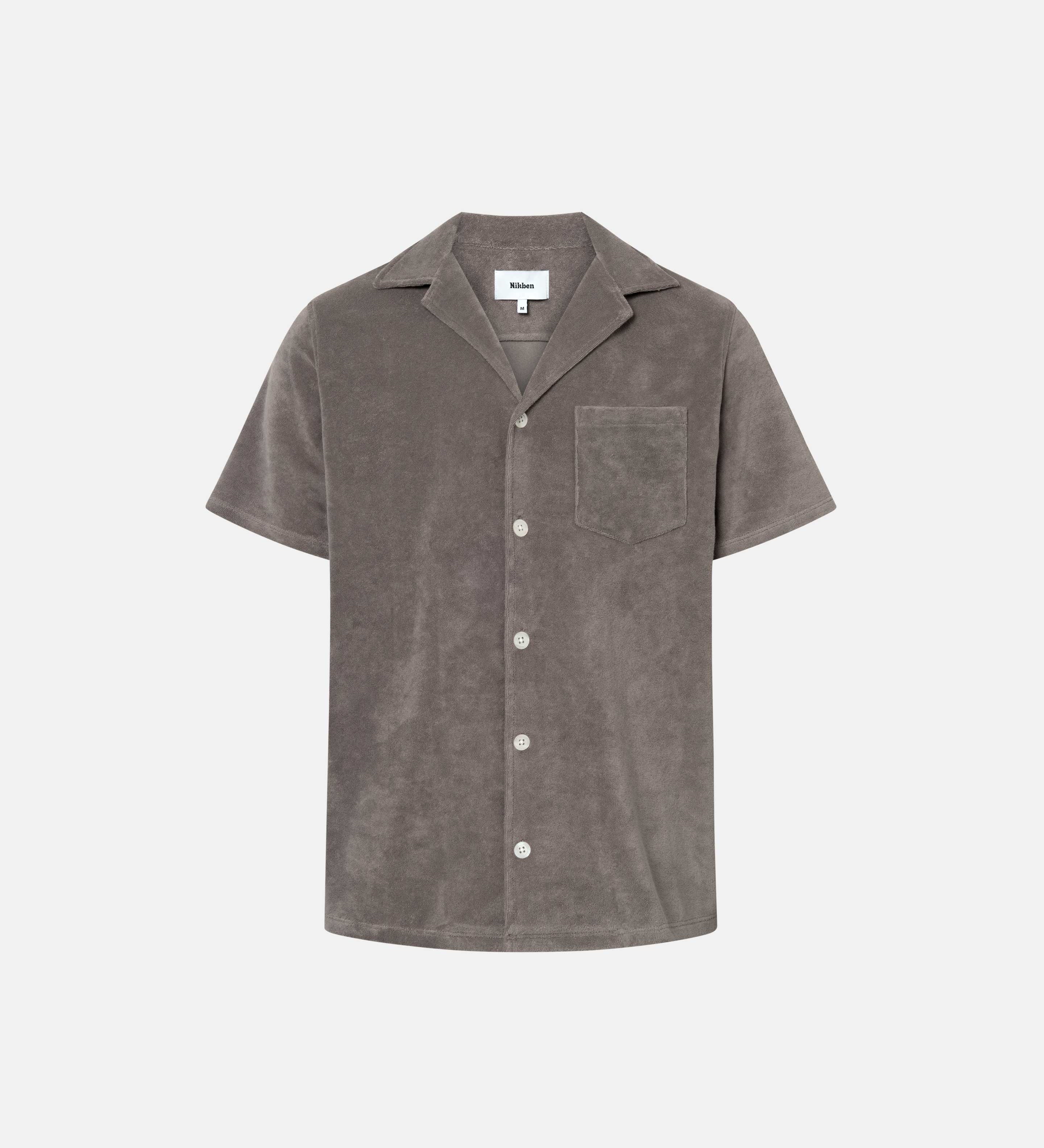 Dark grey short sleeve shirt with white button closure and one chest pocket