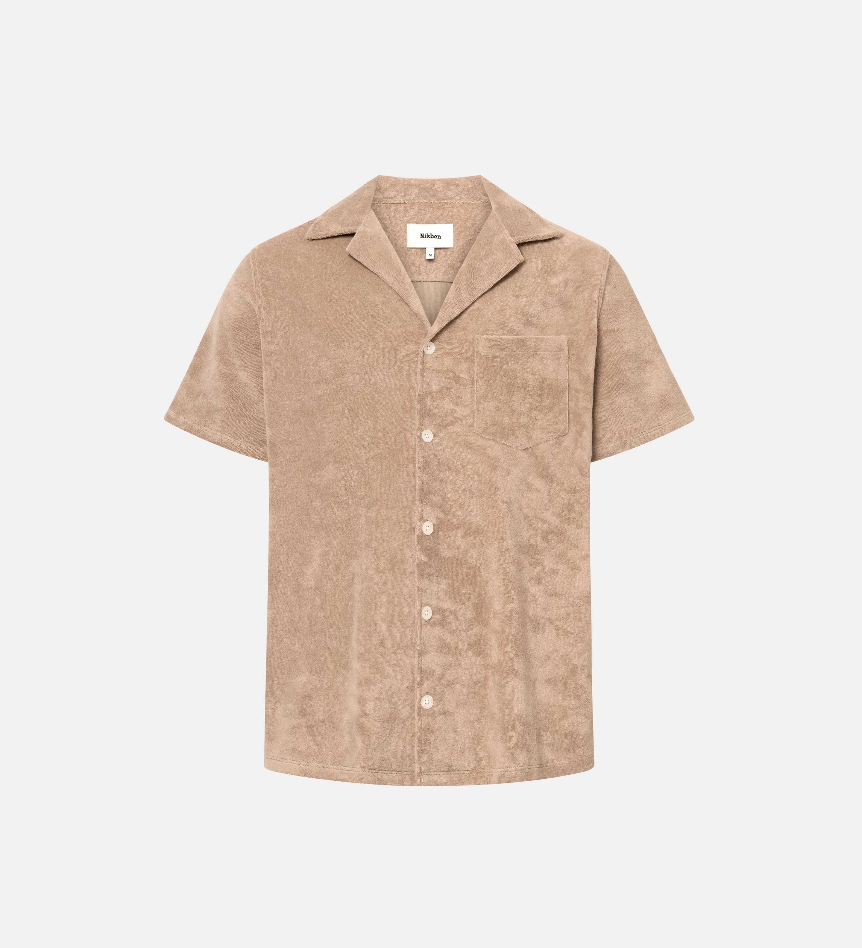 Light brown short sleeve shirt with white button closure and one chest pocket
