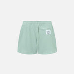 Backside of mint green waffle-patterned mid-length shorts with tone back pocket and logo patch.