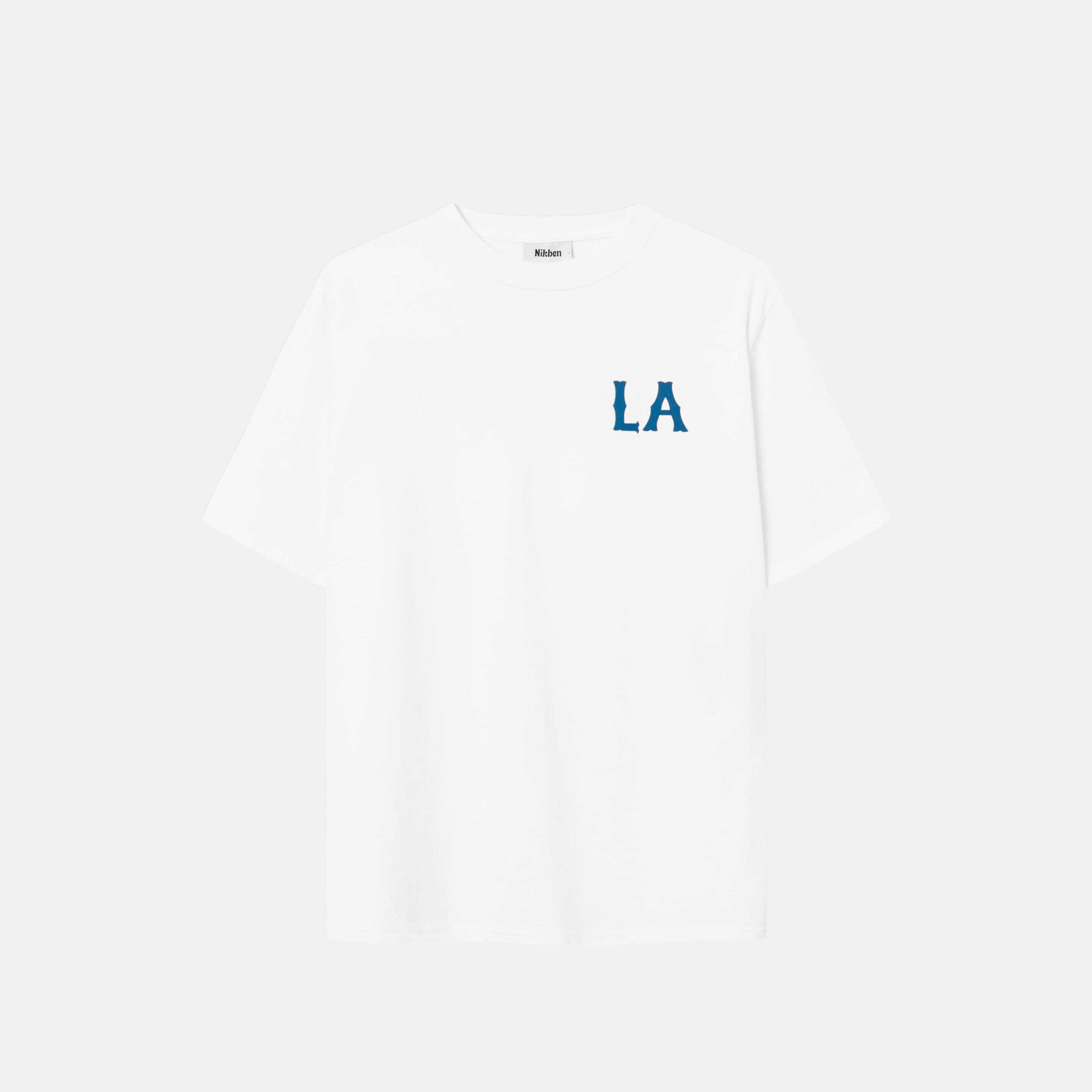 White t-shirt with "LA" chest print in blue letters.
