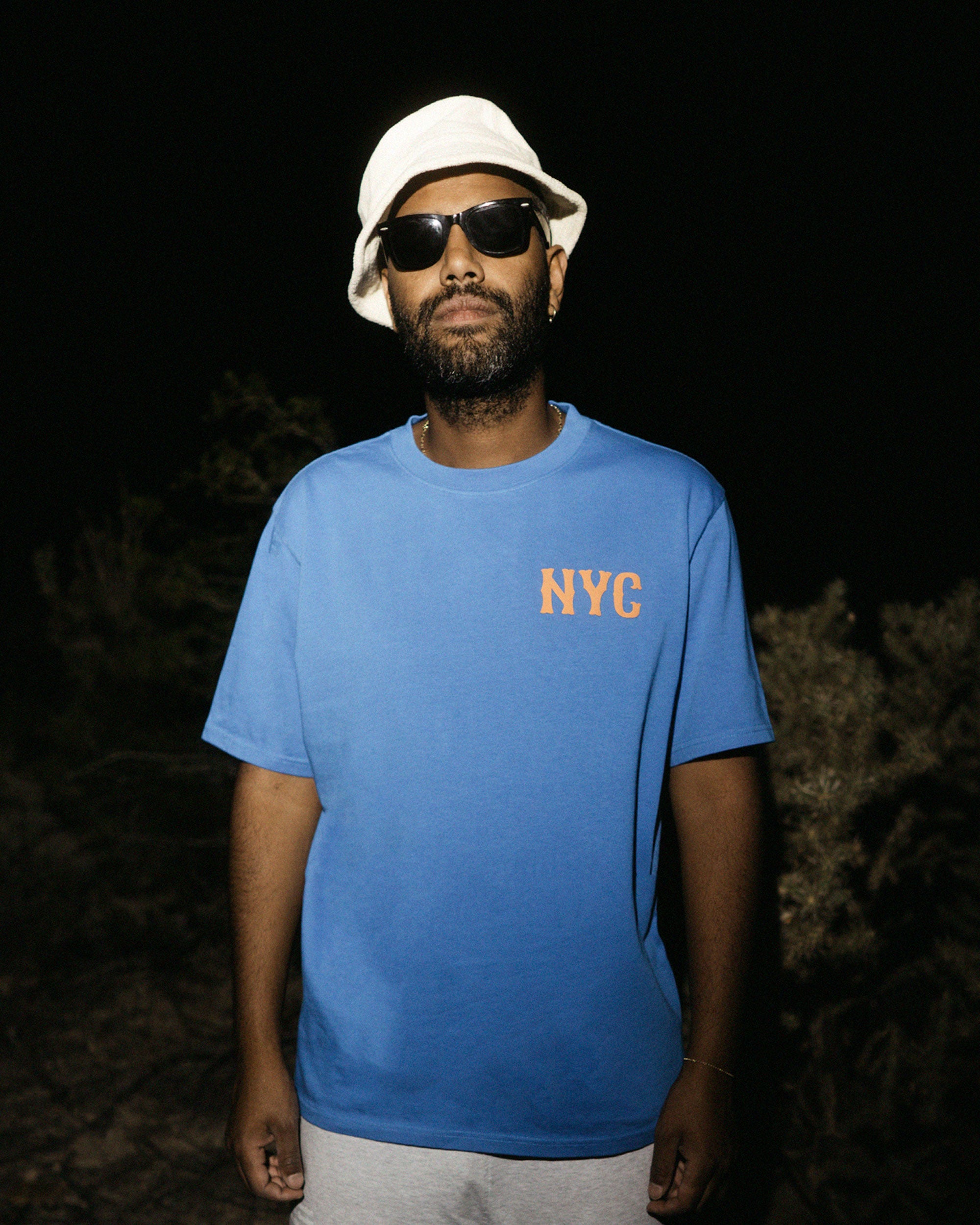 Male model wearing a blue t-shirt with orange 