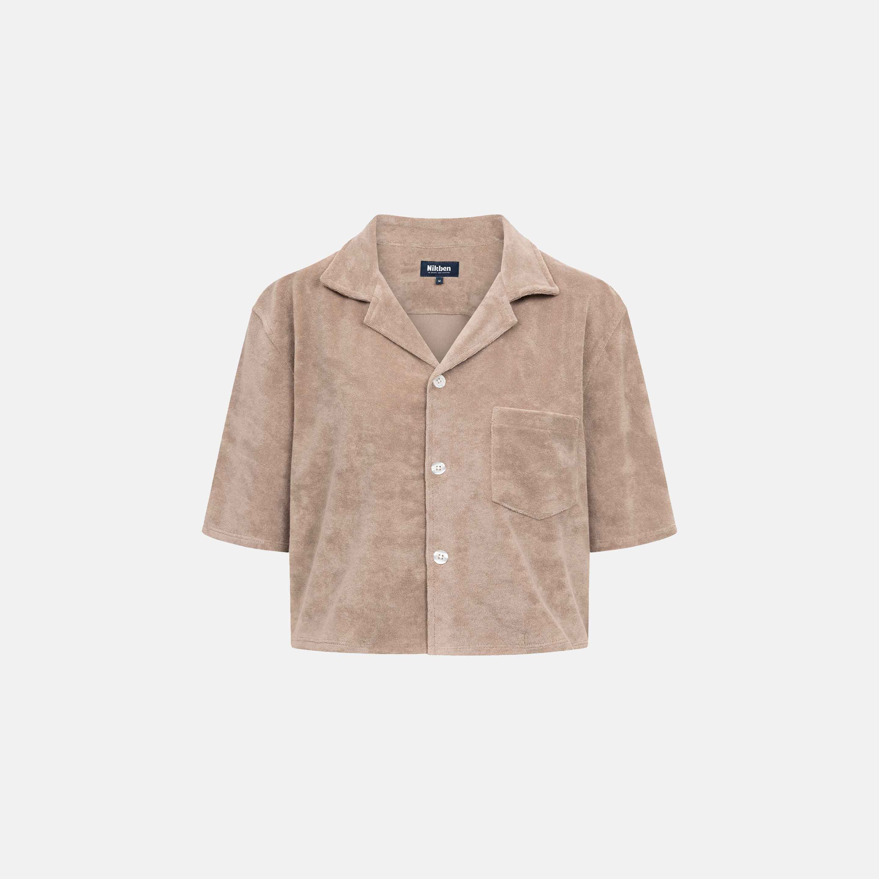 Light brown, short sleeve, cropped shirt with white button closure and one chest pocket