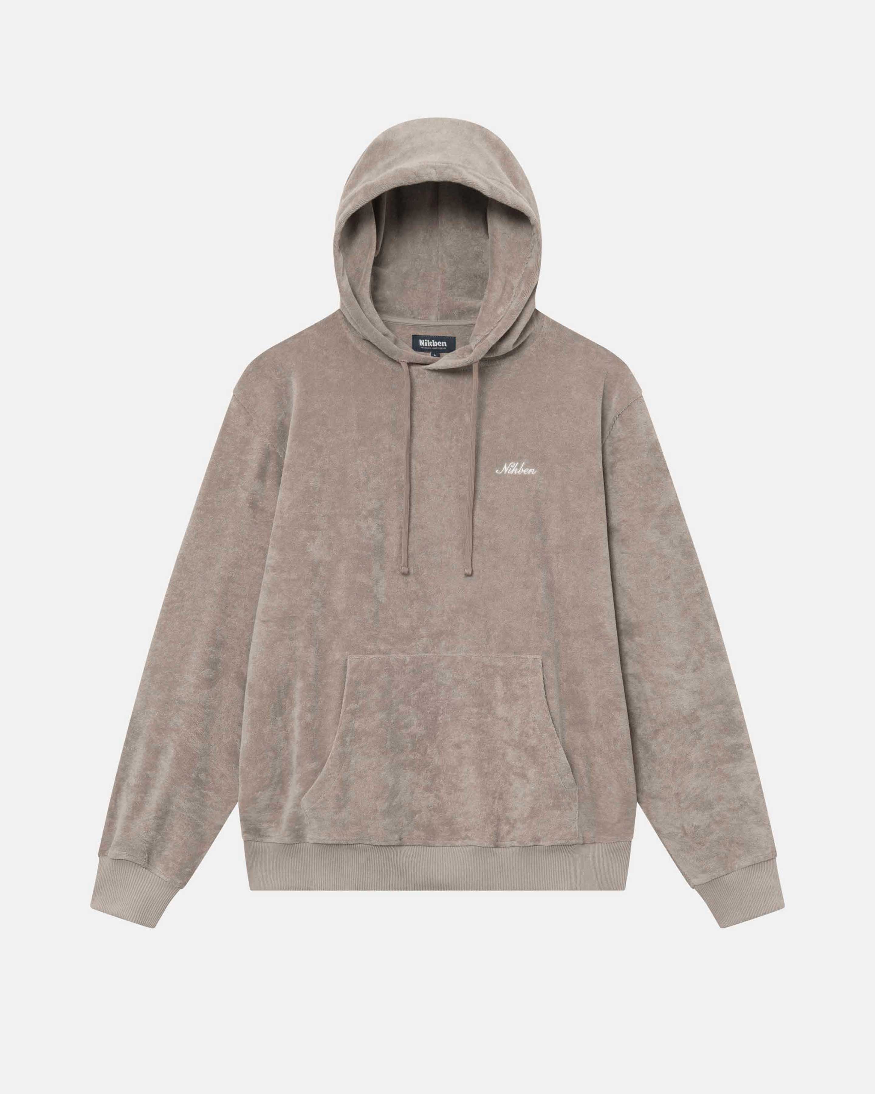 Beige hoodie made from terry toweling cloth. It features drawstrings, a single front pocket, and a white embroidered "Nikben" logo on the chest