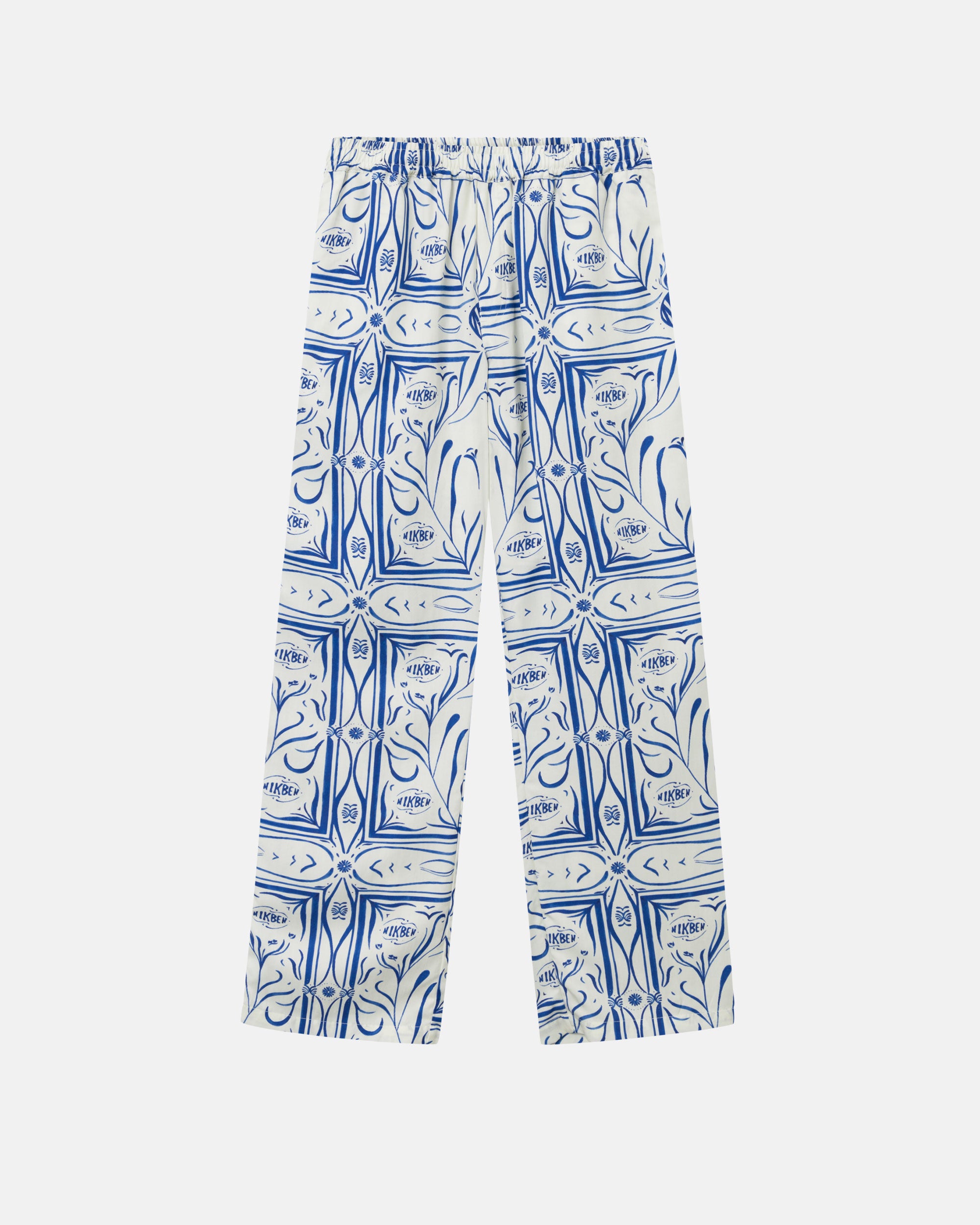 White vacation pants with a blue graphic pattern, two front pockets, and an elastic drawstring.
