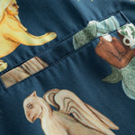 Close-up of breast pocket on a navy vacation shirt with a multi-colored graphic pattern..