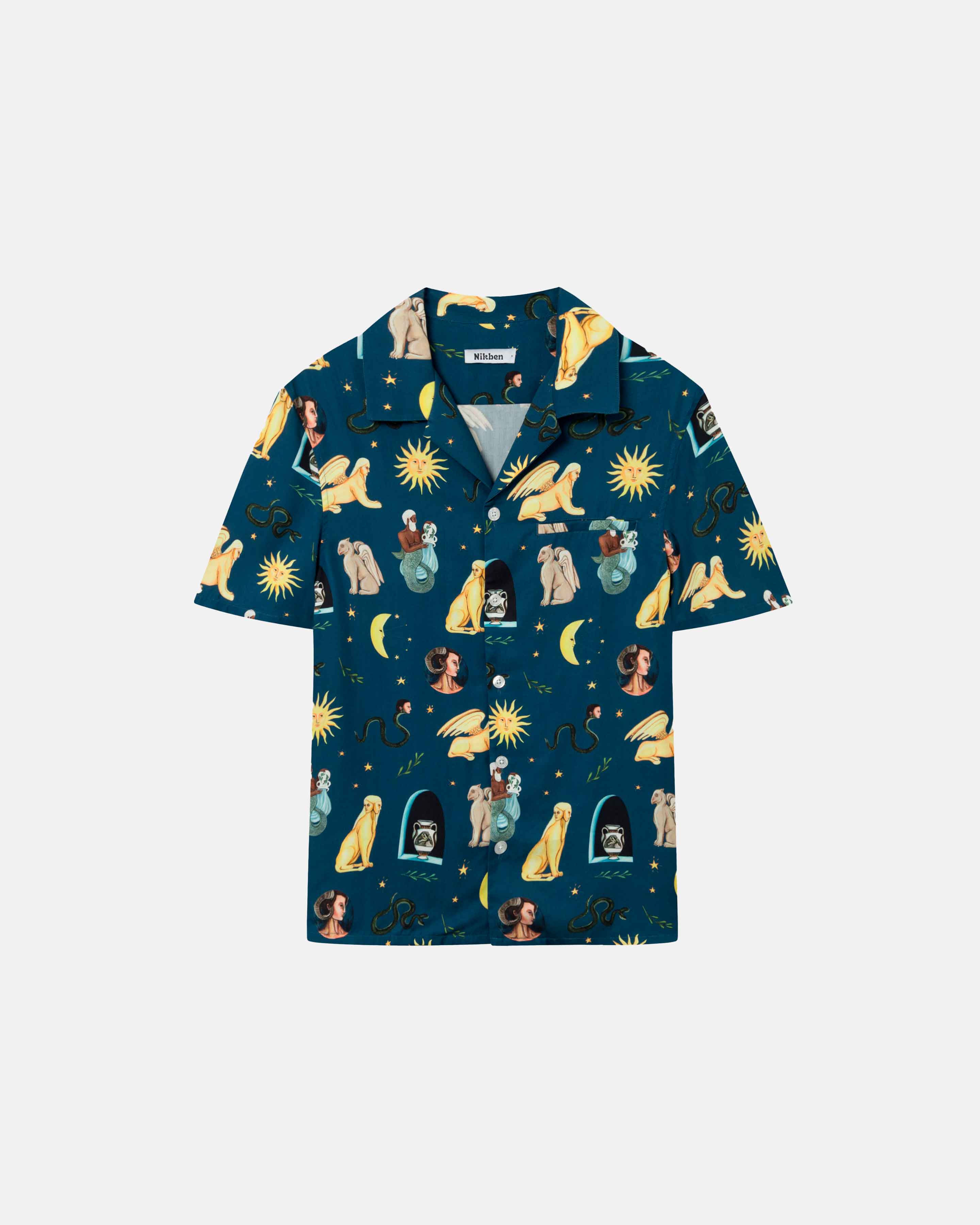 Navy short-sleeved vacation shirt with a multi-colored graphic pattern, open collar, one breast pocket, and button closure.
