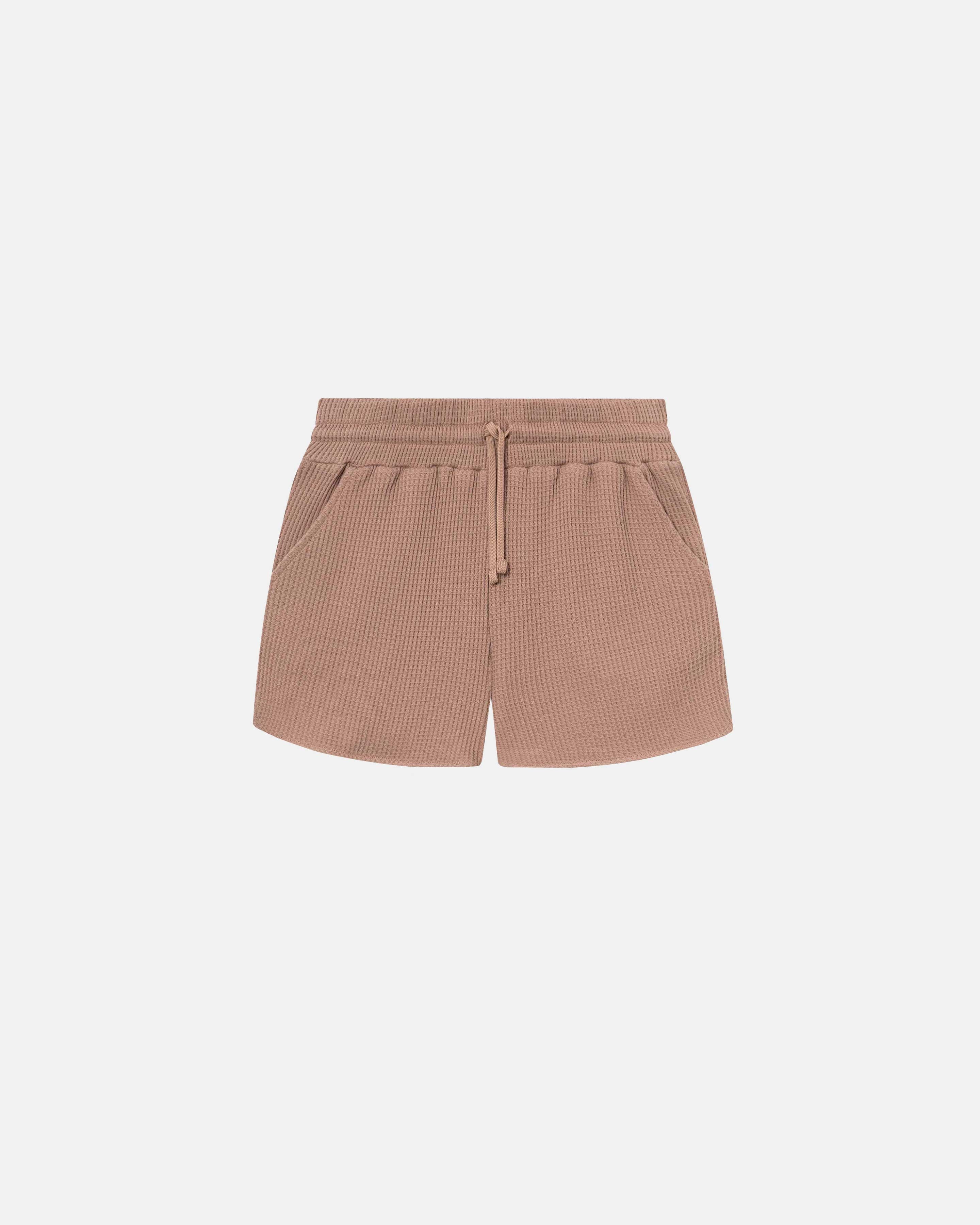 Brown waffle-patterned short-length shorts with two front pockets and a drawstring.