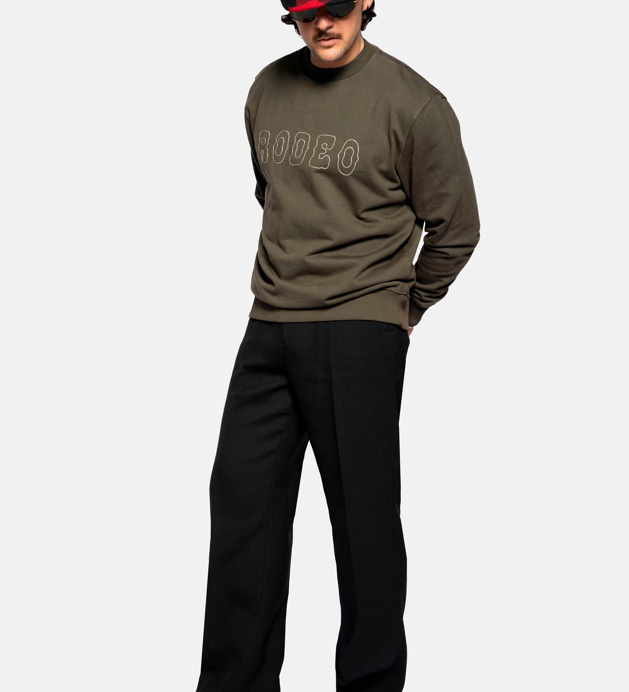 Male model wearing a Tarmac colored sweatshirt with "Rodeo" stitching