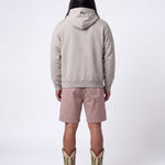 Back of male model wearing grey hoodie with blue flag print on the hood