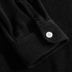 Close up on sleeve on a black kaftan in terry toweling fabric.