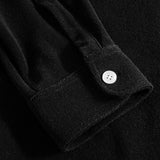 Close up on sleeve on a black kaftan in terry toweling fabric.