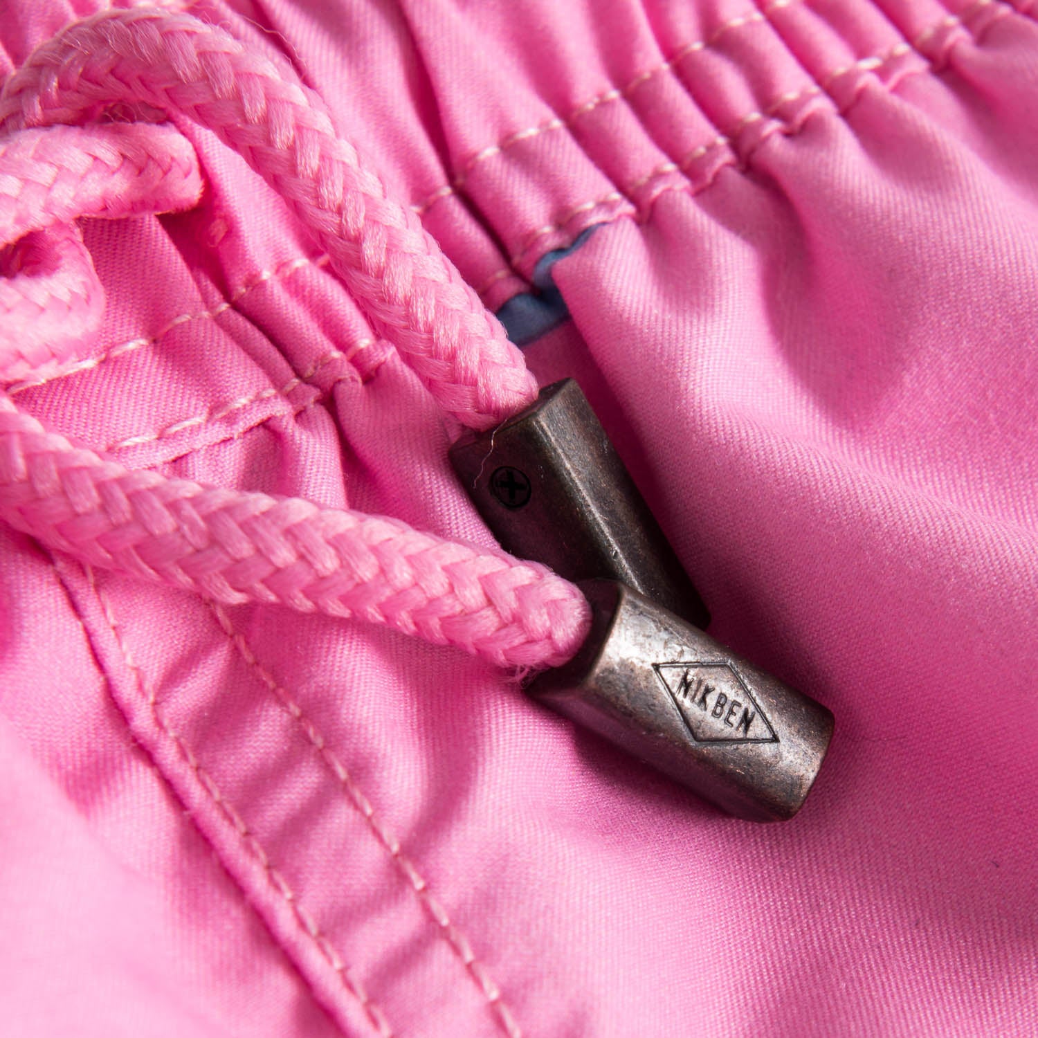 Drawstring waistband on pink printed kids swim trunks