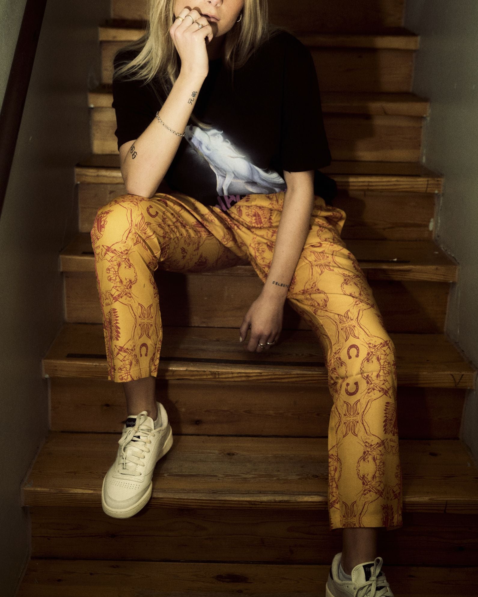 Model wearing yellow, printed pants