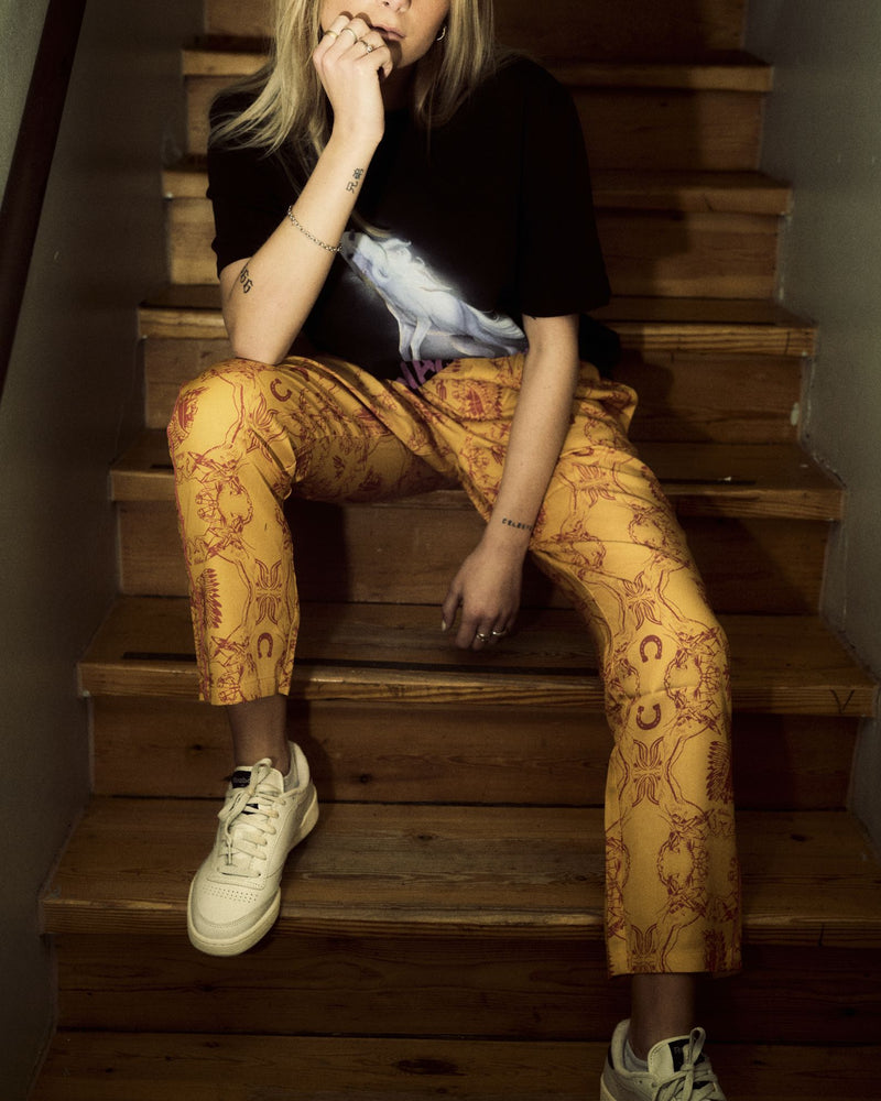 Model wearing yellow, printed pants