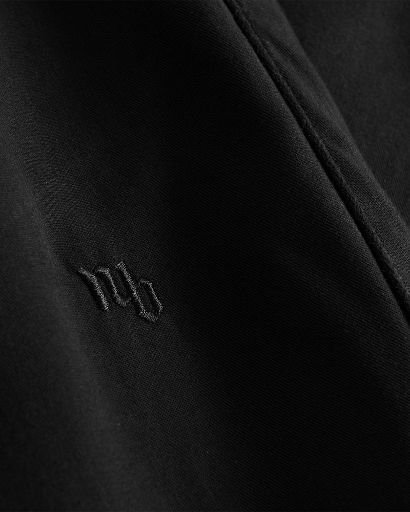 Black NB embroidery on black pants