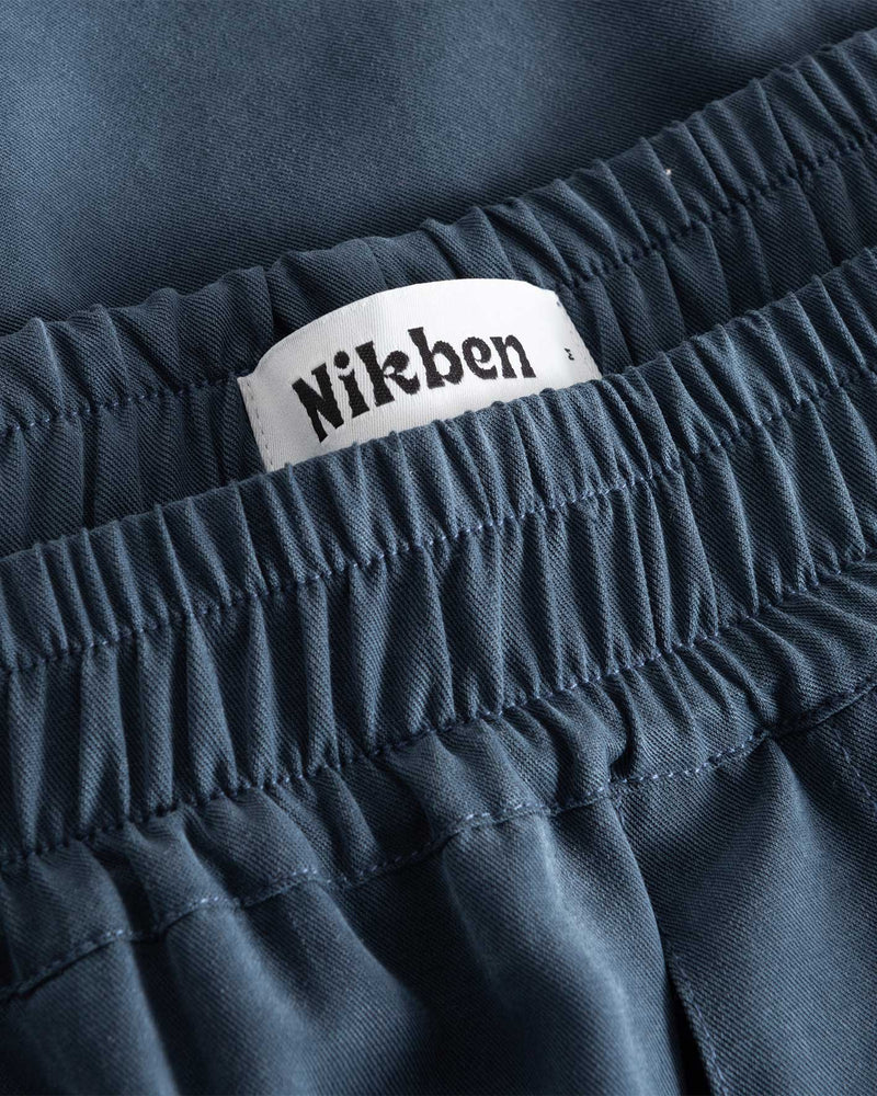 White label on blue pants