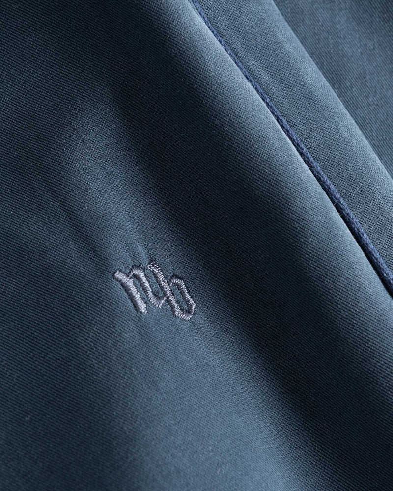 NB embroidery on blue pants