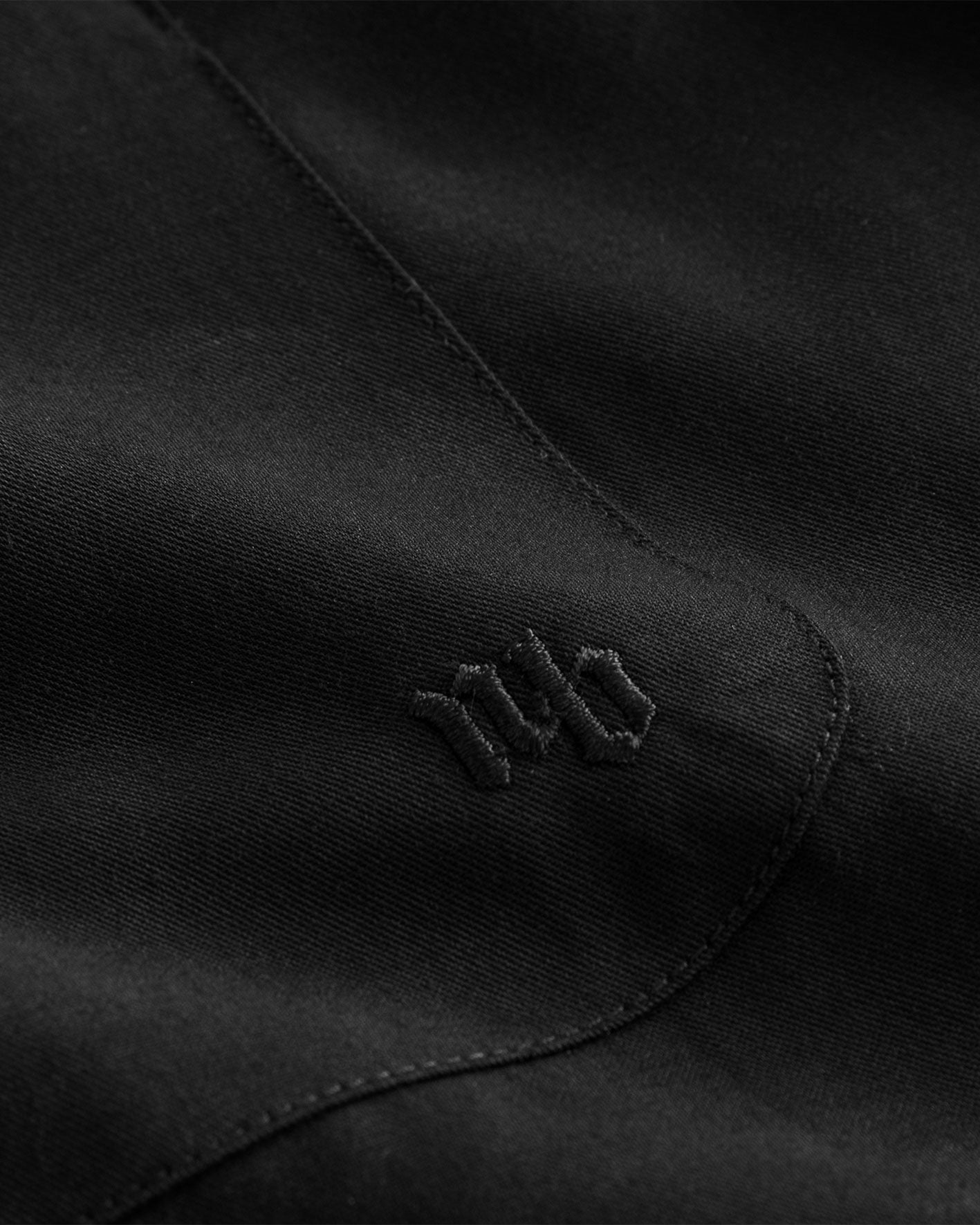 Close up of embroidery on black shirt